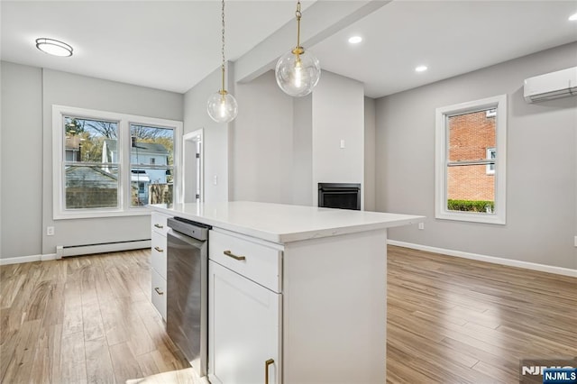 kitchen featuring white cabinets, light wood finished floors, light countertops, decorative light fixtures, and baseboard heating