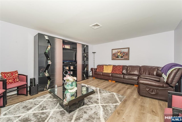 living room with wood finished floors and visible vents