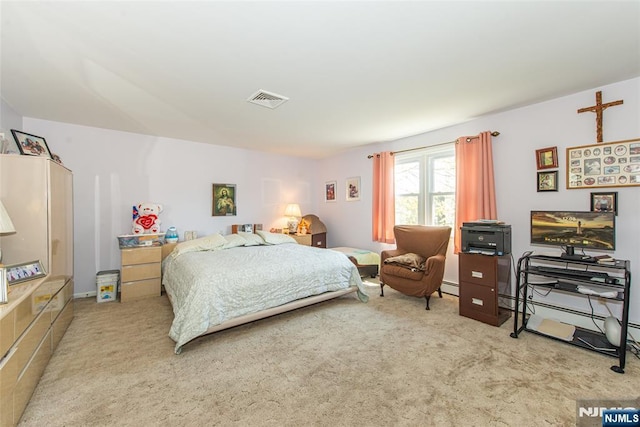 carpeted bedroom featuring a baseboard radiator and visible vents