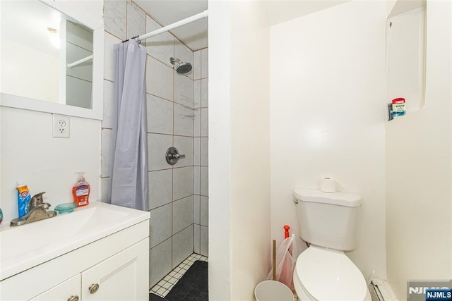 bathroom featuring toilet, vanity, and tiled shower