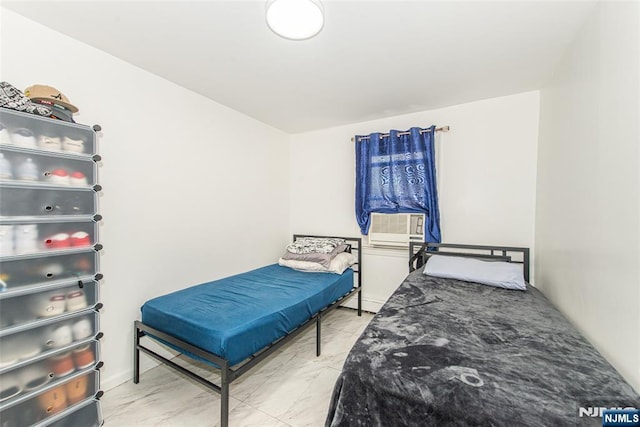 bedroom featuring cooling unit and marble finish floor