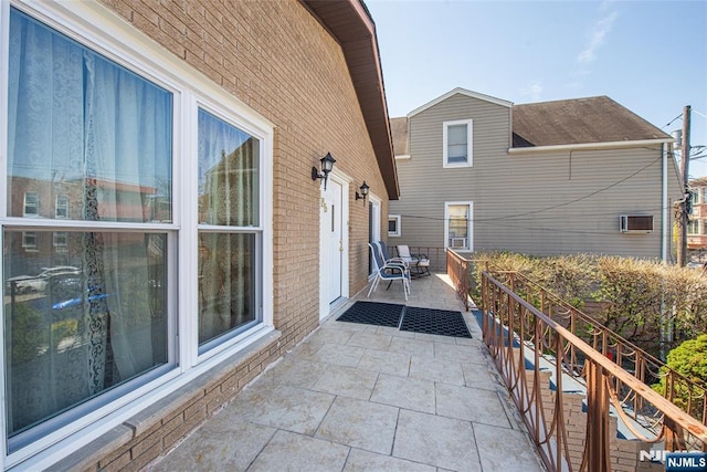 view of side of home with brick siding