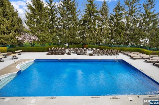 pool featuring a patio and fence