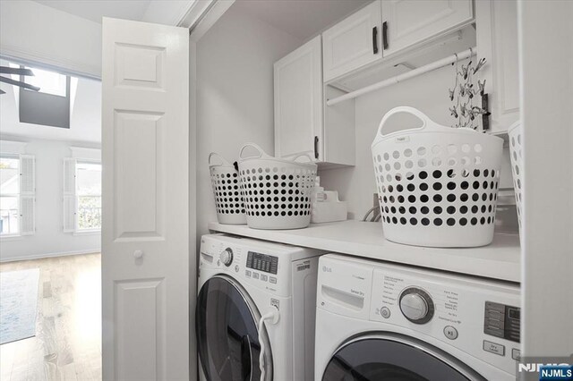 laundry room with separate washer and dryer and wood finished floors