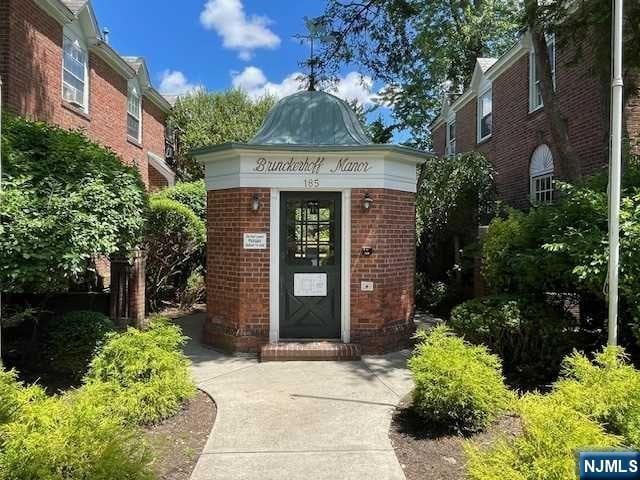 doorway to property featuring brick siding