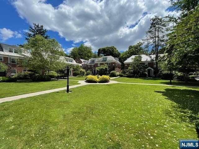 view of home's community featuring a yard and a residential view