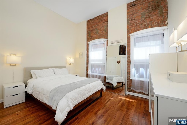 bedroom with dark wood-type flooring