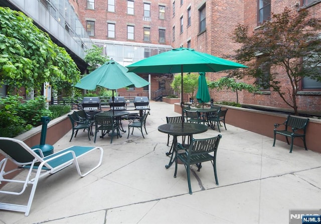 view of patio / terrace with outdoor dining area and a grill