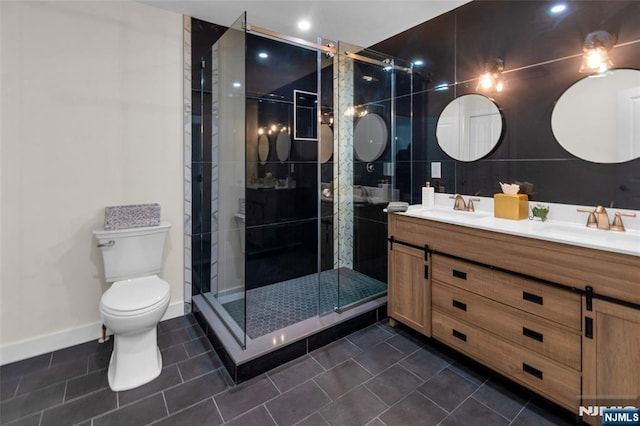 full bathroom featuring toilet, tile patterned flooring, a sink, and a stall shower