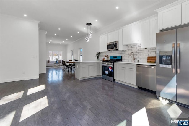 kitchen with backsplash, crown molding, stainless steel appliances, and dark wood-style floors