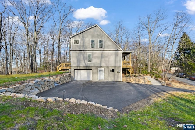 305 Mountainside Dr, Vernon, NJ 07422 - view of property exterior with asphalt driveway, stairway, a garage, and a deck