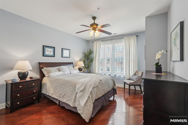 bedroom with baseboards, dark wood finished floors, and ceiling fan