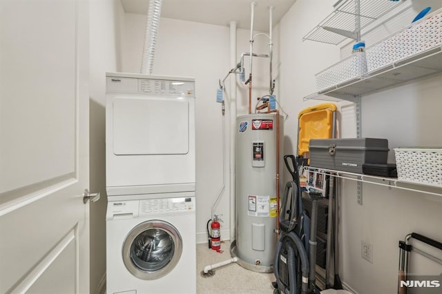 washroom featuring laundry area, carpet flooring, stacked washer / dryer, and electric water heater