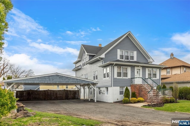 61 Sabina St, Little Ferry, NJ 07643 - view of front of property featuring fence, a carport, and aphalt driveway