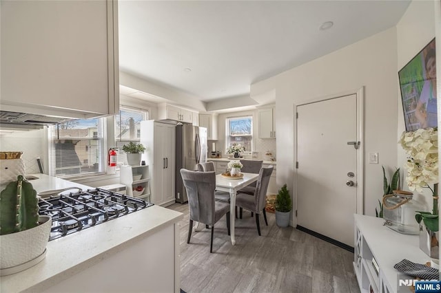 61 Sabina St, Little Ferry, NJ 07643 - kitchen with light countertops, freestanding refrigerator, light wood-style flooring, and white cabinetry