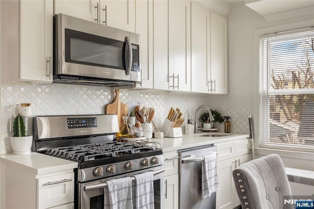 61 Sabina St, Little Ferry, NJ 07643 - kitchen with a sink, white cabinetry, stainless steel appliances, and light countertops
