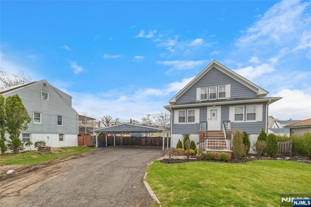 61 Sabina St, Little Ferry, NJ 07643 - view of front of house with a detached carport, driveway, a front lawn, and fence