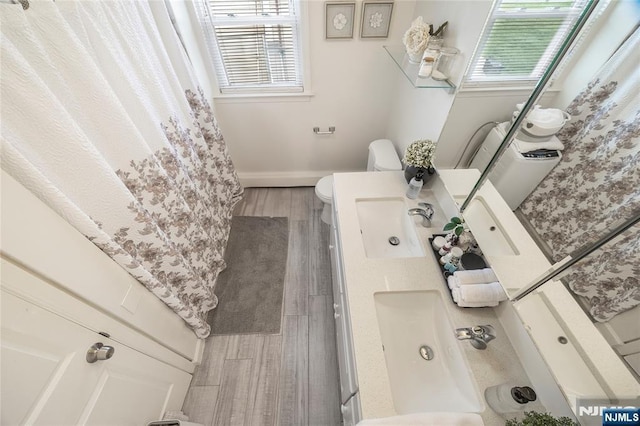 61 Sabina St, Little Ferry, NJ 07643 - full bathroom with toilet, wood finished floors, a sink, and baseboards