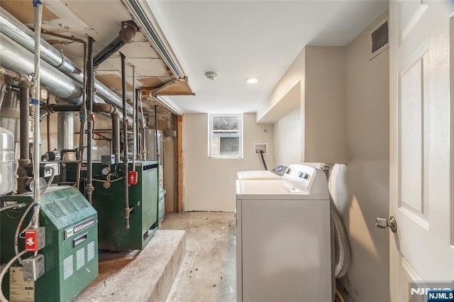 61 Sabina St, Little Ferry, NJ 07643 - laundry area featuring water heater, visible vents, washer and dryer, and a heating unit