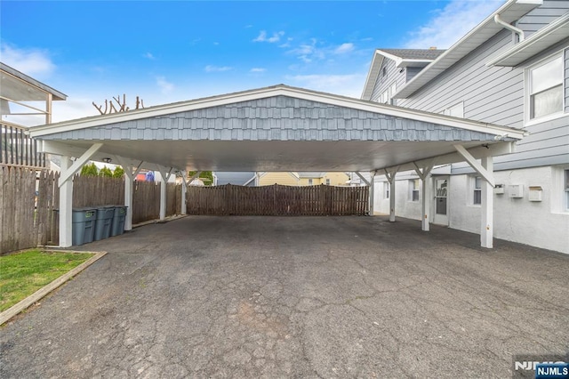 61 Sabina St, Little Ferry, NJ 07643 - view of parking with fence and a carport