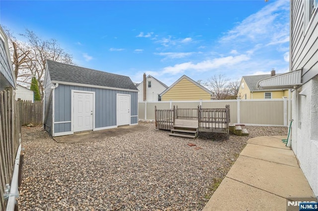 61 Sabina St, Little Ferry, NJ 07643 - view of yard featuring a wooden deck, a fenced backyard, an outdoor structure, and a shed