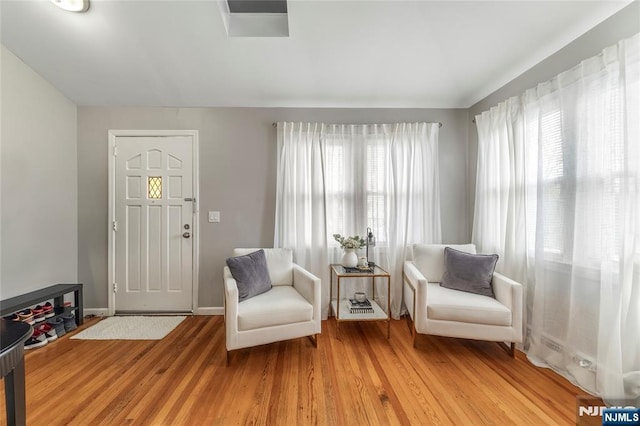 61 Sabina St, Little Ferry, NJ 07643 - sitting room featuring baseboards, lofted ceiling, and light wood-type flooring