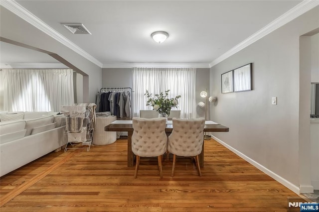 61 Sabina St, Little Ferry, NJ 07643 - dining space with light wood-type flooring, visible vents, baseboards, and ornamental molding