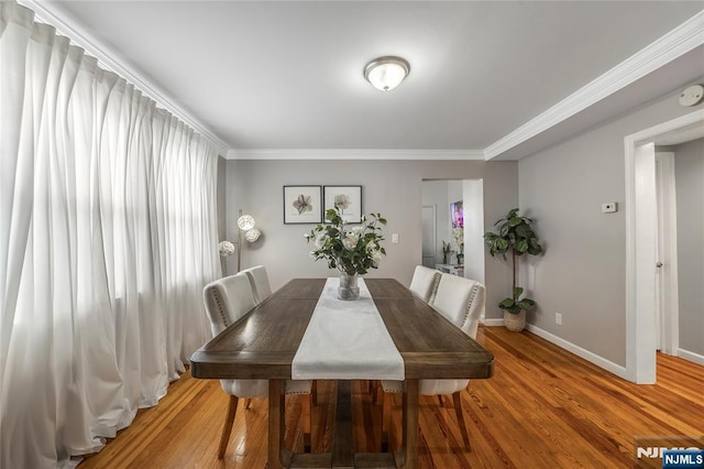 61 Sabina St, Little Ferry, NJ 07643 - dining space featuring light wood finished floors, baseboards, and ornamental molding