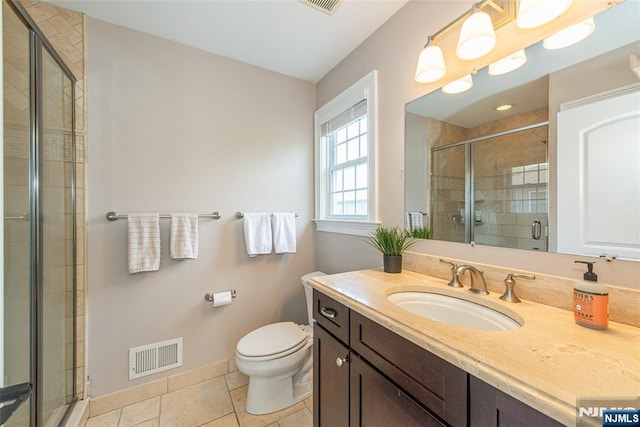 full bathroom featuring visible vents, a stall shower, vanity, baseboards, and toilet