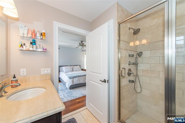 bathroom with ceiling fan, a shower stall, ensuite bathroom, and vanity