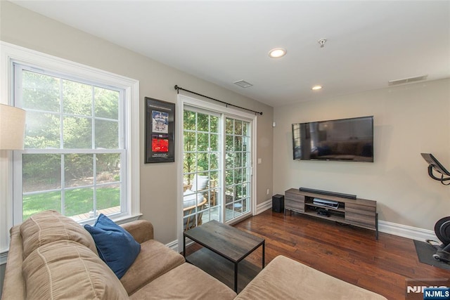 living room with baseboards, recessed lighting, wood finished floors, and visible vents