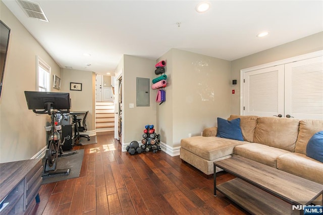 living area featuring recessed lighting, baseboards, visible vents, hardwood / wood-style flooring, and electric panel