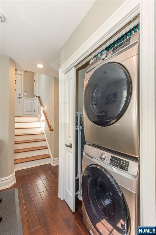 washroom with laundry area, recessed lighting, baseboards, stacked washer / dryer, and dark wood-style floors