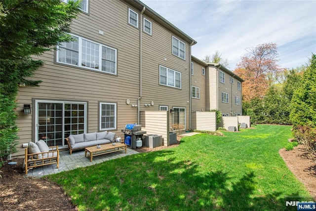 back of house featuring a patio, a lawn, central AC, and an outdoor hangout area