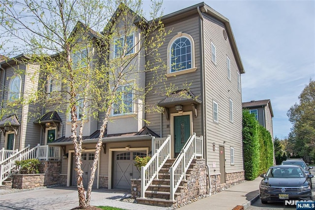 townhome / multi-family property featuring a garage and driveway