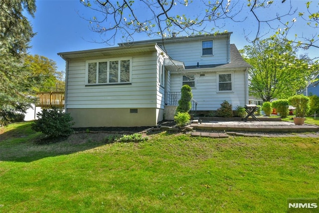 back of house with a lawn