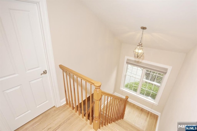 stairs featuring wood finished floors and baseboards