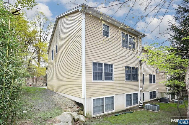 view of side of property featuring central AC unit