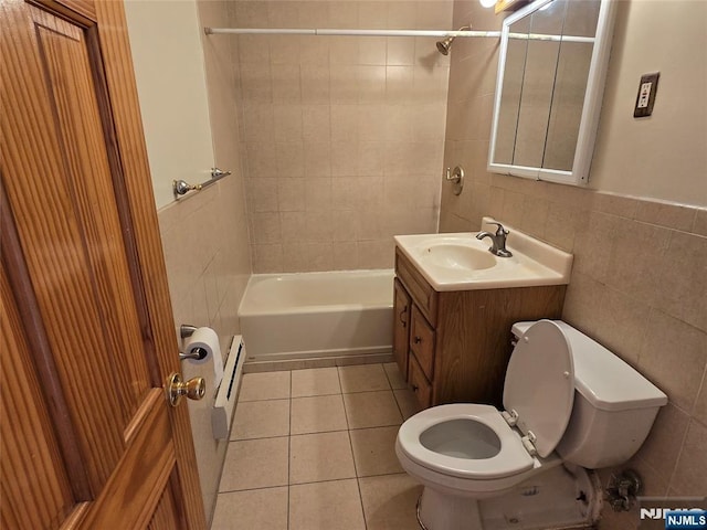 270 Marin Blvd Unit 12-O, Jersey City, NJ 07302 - full bathroom featuring tile walls, a baseboard heating unit, vanity, tile patterned floors, and bathing tub / shower combination