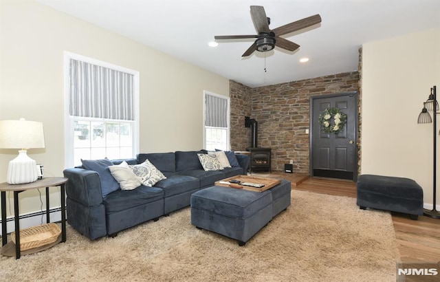 28 White Birch Ter, Kinnelon Borough, NJ 07405 - living room featuring a wood stove, wood finished floors, baseboard heating, recessed lighting, and a ceiling fan