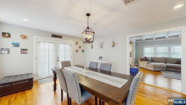 dining space with light wood-type flooring, visible vents, recessed lighting, and a chandelier