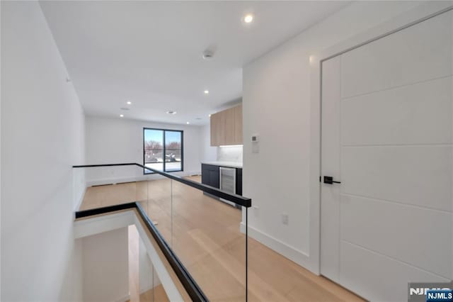 kitchen with light wood-type flooring, baseboards, recessed lighting, modern cabinets, and light countertops