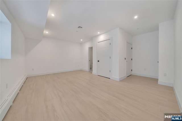 additional living space with visible vents, baseboards, recessed lighting, and light wood-type flooring