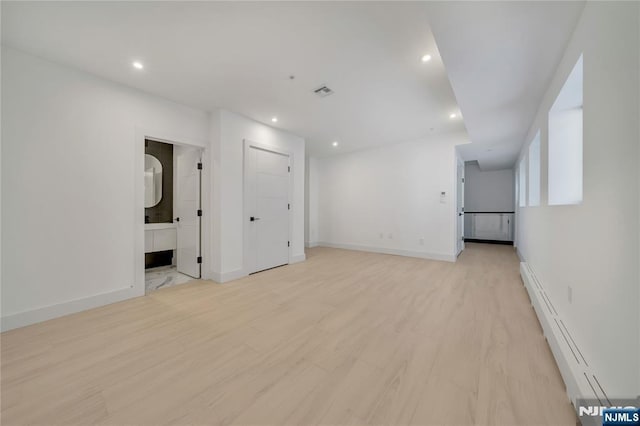 unfurnished living room featuring light wood finished floors, visible vents, baseboards, recessed lighting, and baseboard heating