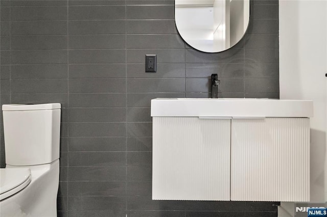 half bath featuring toilet and vanity