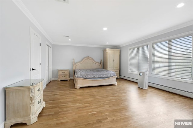 bedroom with crown molding, baseboards, a baseboard heating unit, and light wood finished floors