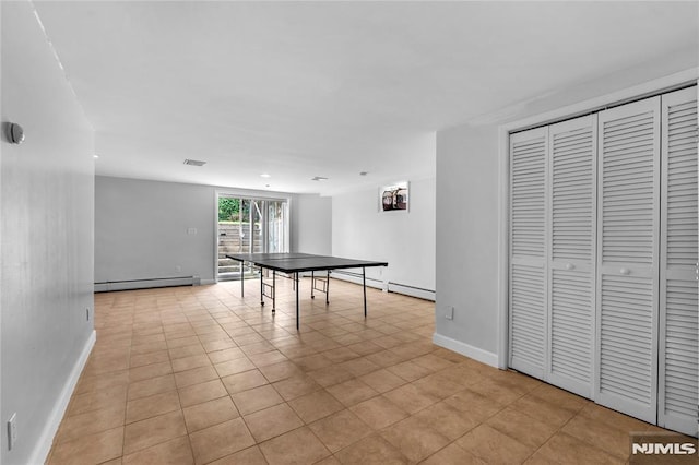 rec room with baseboards, a baseboard radiator, and visible vents