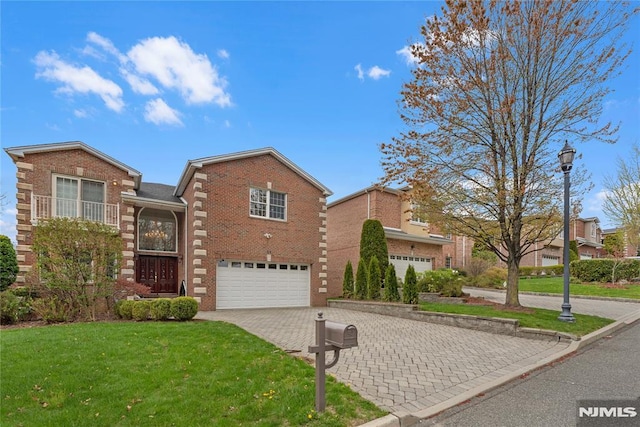 view of front facade with an attached garage, decorative driveway, a front yard, and brick siding