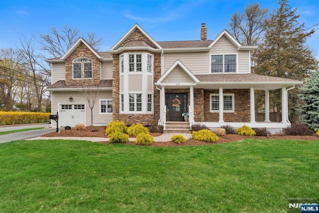 view of front of property with a garage, stone siding, a chimney, and a front lawn