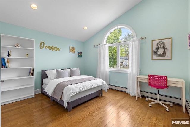 bedroom with light wood-style floors, a baseboard radiator, and lofted ceiling